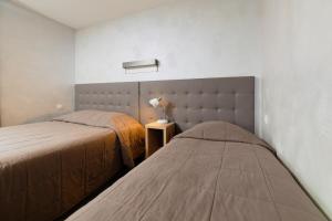 Postel nebo postele na pokoji v ubytování Motel D'ornex