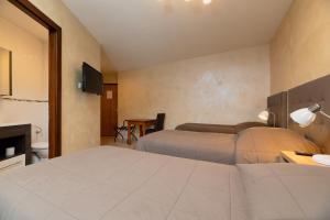Postel nebo postele na pokoji v ubytování Motel D'ornex