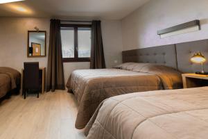 Postel nebo postele na pokoji v ubytování Motel D'ornex