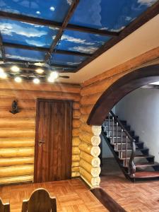 a room with a wooden staircase and a wooden door at Holiday House Karavella in Abzakovo