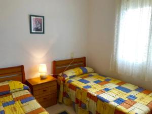 a bedroom with two beds and a dresser and a window at MEDDAYS VILLA HORUS CON PISCINA PRIVADA in Miami Platja +28 photos