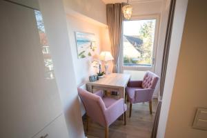 a room with a table and two chairs and a window at Abendsonne in Westerland +2 photos