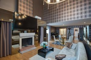 a living room with a couch and a fireplace at Penthouse Suite Rome in Rome