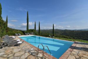 a swimming pool with a view of a mountain at Vin Santo in Castelnuovo Berardenga