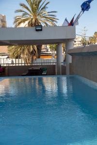 a swimming pool with blue water in a building at Motel Aviv in Eilat