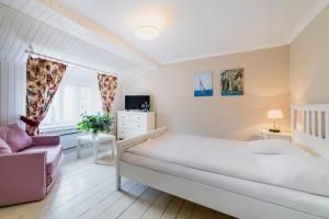 Łóżko lub łóżka w pokoju w obiekcie Apartamenty Portowe