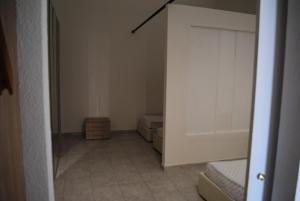 an empty room with two beds and a closet at Luxar room in Assemini +54 photos