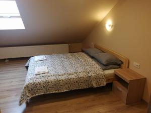 a small bedroom with a bed with two towels on it at Viešbutis Kelyje in Utena