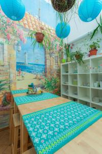 a room with a table with a mural of a beach at Итальянские комнаты и апартаменты Пио на Моховой 39 in Saint Petersburg