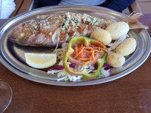 a plate of food with a fish on a table at Casa Veon Fuerteventura in Costa de Antigua