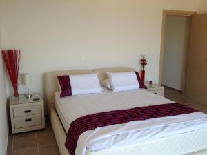 a bedroom with a large bed with two pillows at Villa Anna in Pefki Rhodes +29 photos