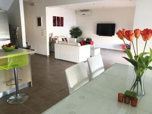 a living room with a table with a vase of flowers at Villa Anna in Pefki Rhodes