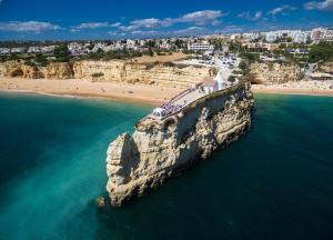 an aerial view of a beach with a rock in the water at Casa Pelourinho in Silves