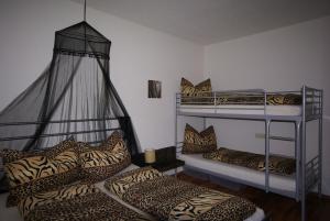 two bunk beds in a room with leopard pillows at Apart Via Claudia Augusta in Ried im Oberinntal