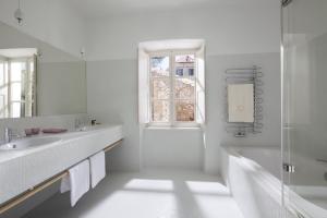 a white bathroom with two sinks and a window at Villa Orti in Dubrovnik +19 photos
