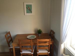 a dining room table with chairs and a plant on it at The Green House Guesthouse in Sunnemo +45 photos
