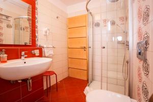 a bathroom with a sink and a shower at Apartments Romano in Rovinj +64 photos