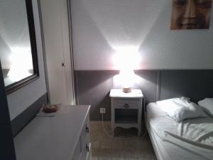 グリュイッサンにある480 Rue de la Huneのベッドルーム1室(ベッド1台、ランプ付きテーブル付)