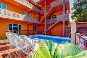 a swimming pool in front of a house at Hummingbird Home Suites in San Pedro