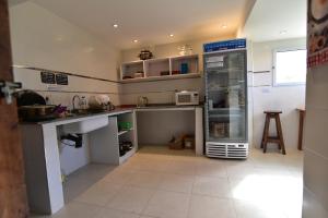 a kitchen with a sink and a refrigerator at Rancho Aparte Hostel in El Chalten