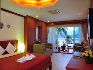 a hotel room with a bed and a living room at Baan Boa Resort in Patong Beach