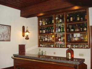 a bar with a lot of alcohol bottles at Hotel Sinagoga in Tomar