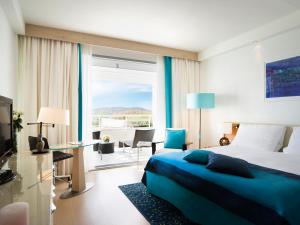 a hotel room with a bed and a large window at Sun Gardens Dubrovnik in Dubrovnik +37 photos