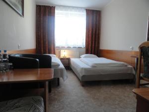 Łóżko lub łóżka w pokoju w obiekcie Hotel Górecki