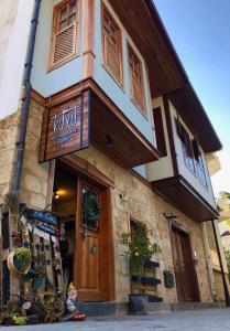 a building with a sign on the front of it at Kuyu Beergarden Hostel in Antalya