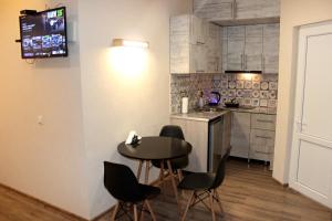 a kitchen with a table and chairs in a room at Apartment Kutaisi in Kutaisi