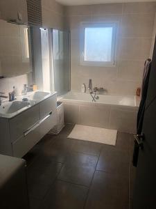 a bathroom with a tub and a sink and a bath tub at 3 Impasse Louis Bassède in Argelès-sur-Mer +16 photos