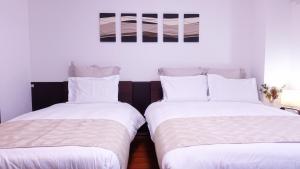 two beds sitting next to each other in a room at COCORO HOTEL in Kyoto