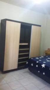 a bedroom with a bed with an american flagolate at 3 Kitnets in Rio das Ostras
