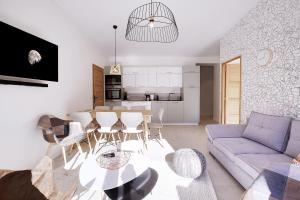 a living room with a couch and a table at Les Clés du Clos in Brides-les-Bains