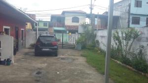 a car parked in a driveway in a house at 3 Kitnets in Rio das Ostras