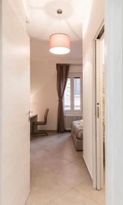 a hallway with a room with a bed and a light at MINERVA GUEST HOUSE in Pavia