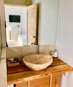 a bathroom with a stone sink and a mirror at So KohKoon Beach Resort in Bang Rak Beach