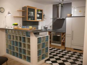 a kitchen with a large counter with glass doors at Ferienwohnung E. und E. Walter in Horn-Bad Meinberg