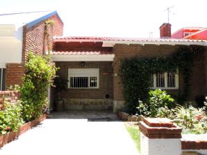 a brick house with a gate in front of it at Ezenahí de la Cruz del Mar in Mar del Plata