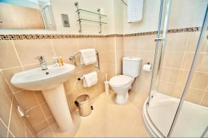 a bathroom with a sink and a toilet and a shower at The Burlington Hotel in Cleethorpes