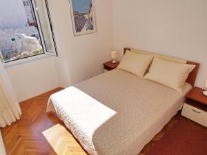 a small bedroom with a bed and a window at Apartment Kameo with terrace in Dubrovnik