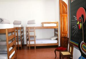 a room with four bunk beds and a table at Hostel 2300 Thomar in Tomar