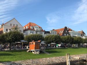 a group of houses and a park with a playground at Ferienwohnung Fährblick Moba-Travel in Travemünde