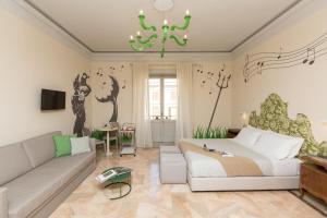 a living room with a bed and a couch at Tritone 125 Suite in Rome