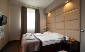 Posteľ alebo postele v izbe v ubytovaní Hotel Villa Völgy Wellness & Konferencia