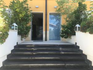 a building with stairs leading to a door at Residenza RoMa in Tropea