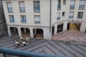 - une vue de tête sur un bâtiment avec des escaliers et des tables dans l'établissement STUDIO CENTRE VILLE COMPIÈGNE, à Compiègne