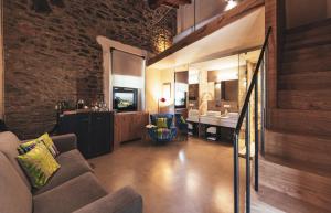 a living room with a couch and a bathroom at Torre di Baratti Bio Resort in Populonia