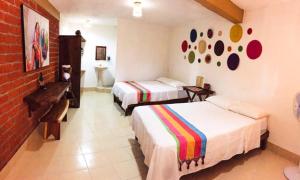 En eller flere senger på et rom på Hotel Casa del Mar Mazunte