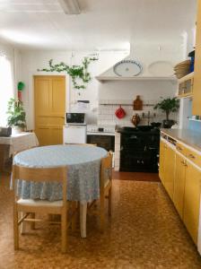a kitchen with a table and chairs in a room at STF Vandrarhem Edsbyn in Edsbyn